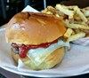 Eating Burger Sandwich Salad at Joy Burger Bar restaurant in New York, NY.